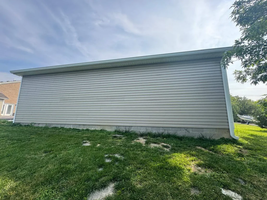 New vinyl siding installed on a shed in Taylorsville KY with clean horizontal panels and finished trim