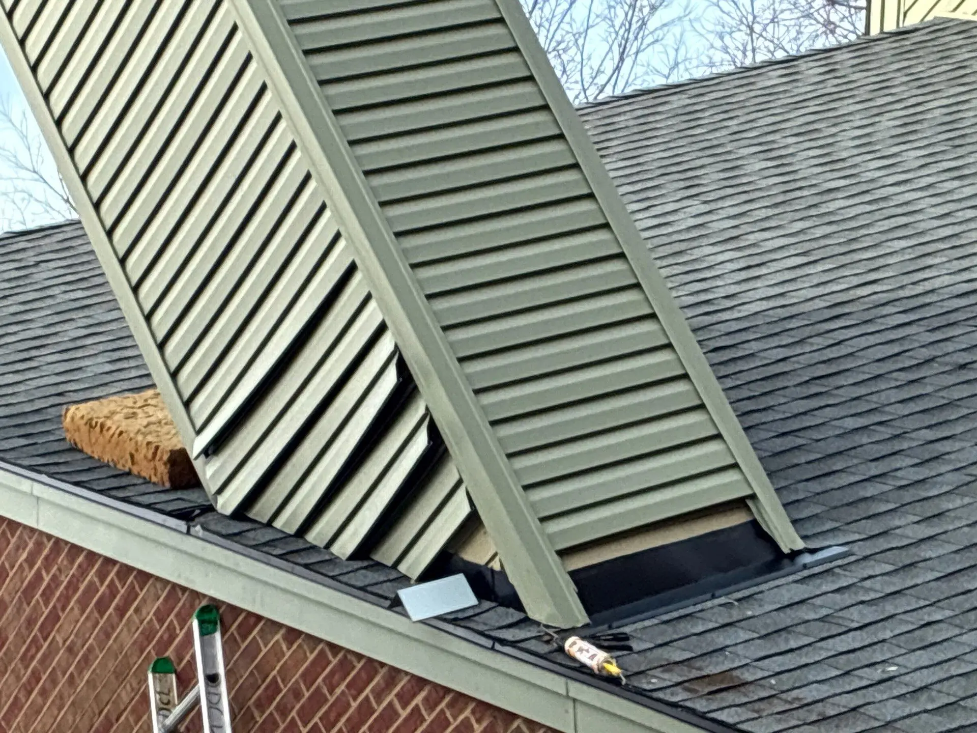 Damaged chimney flashing and roofline on a residential home in Lexington Kentucky