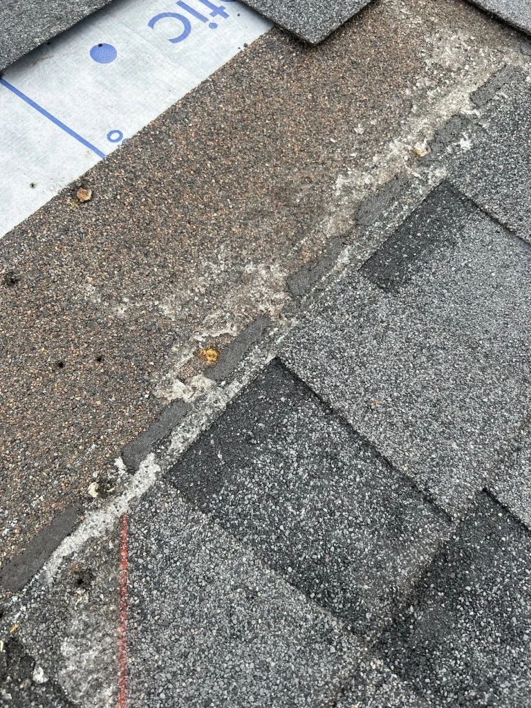 Damaged asphalt roof shingles on a residential home in Lexington Kentucky