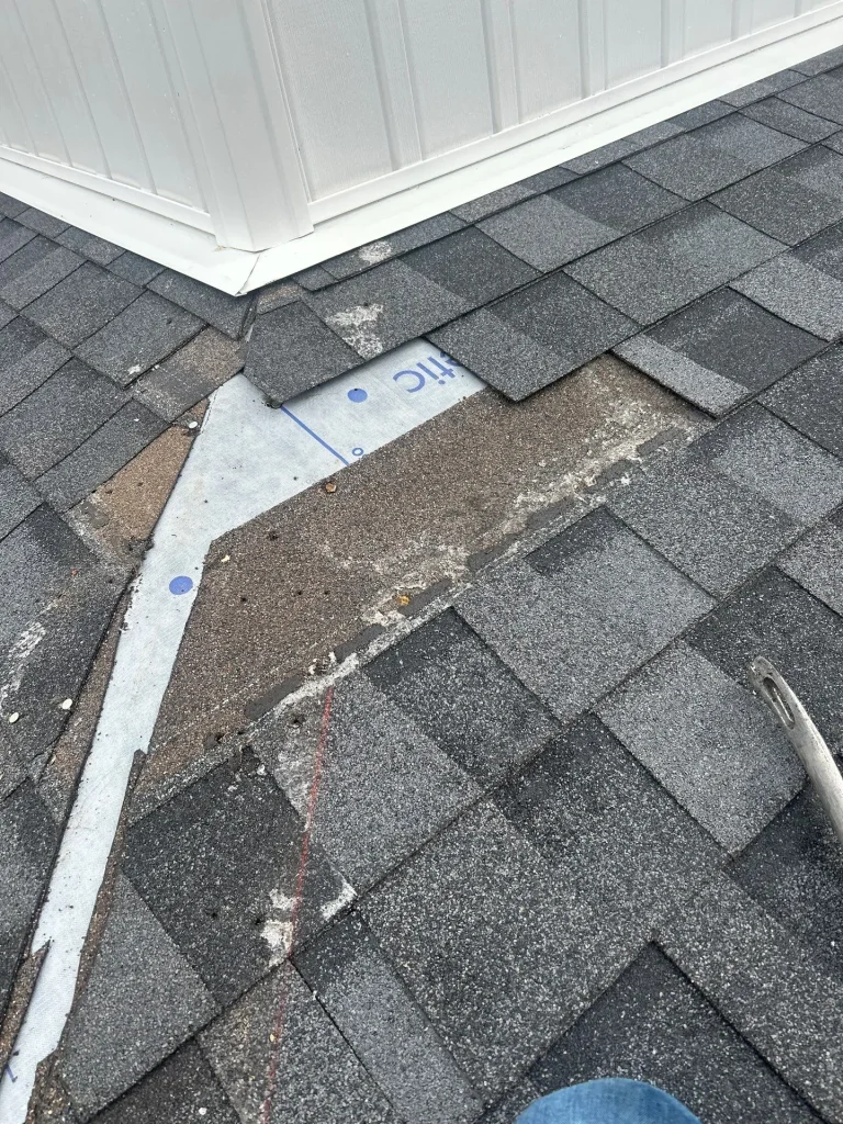 Damaged shingles and exposed underlayment around roof dormer on Lexington Kentucky home