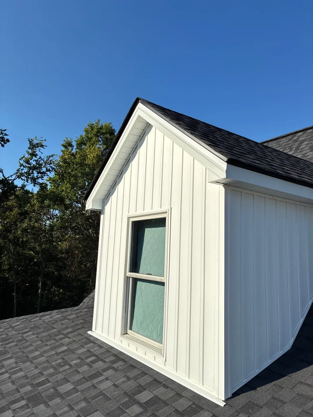 Repaired roof dormer with new shingles and siding on residential home in Lexington Kentucky