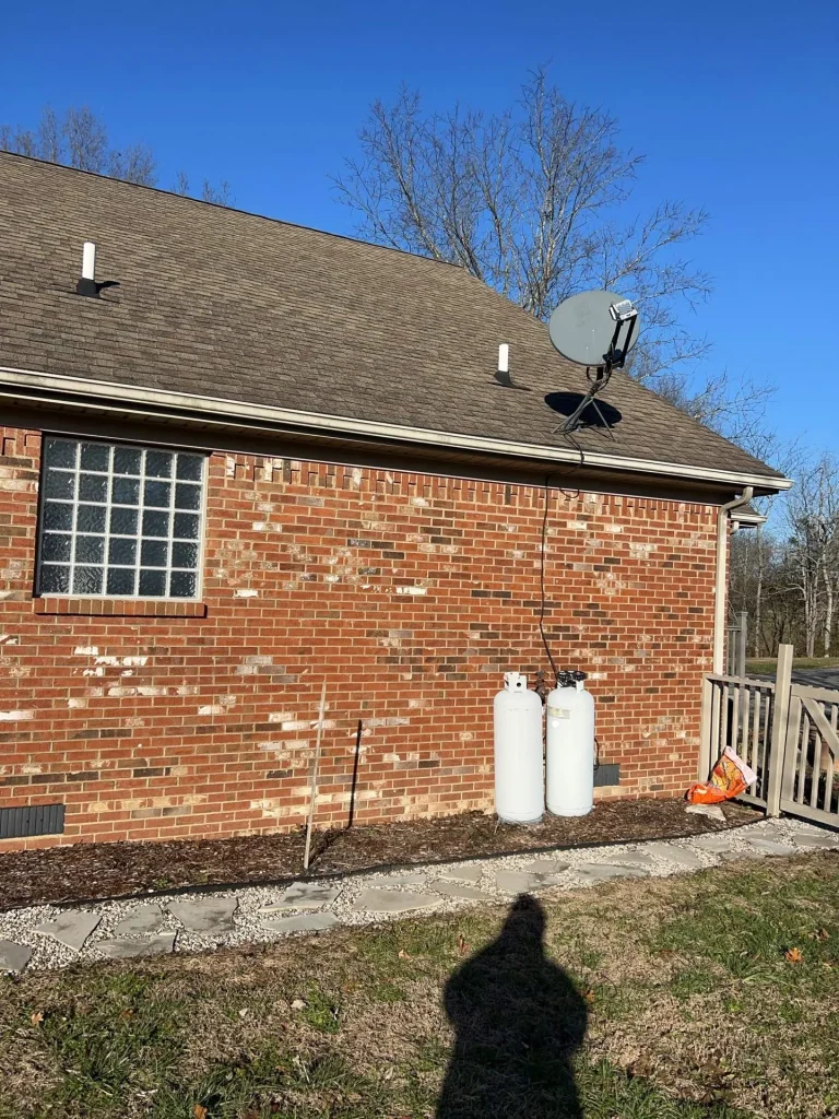 Residential home with installed gutter system managing roof runoff along roofline.