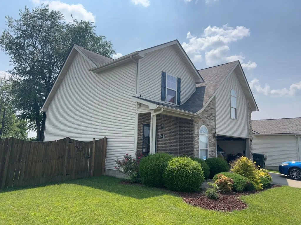 Residential home with installed gutter system along roofline for rainwater drainage.