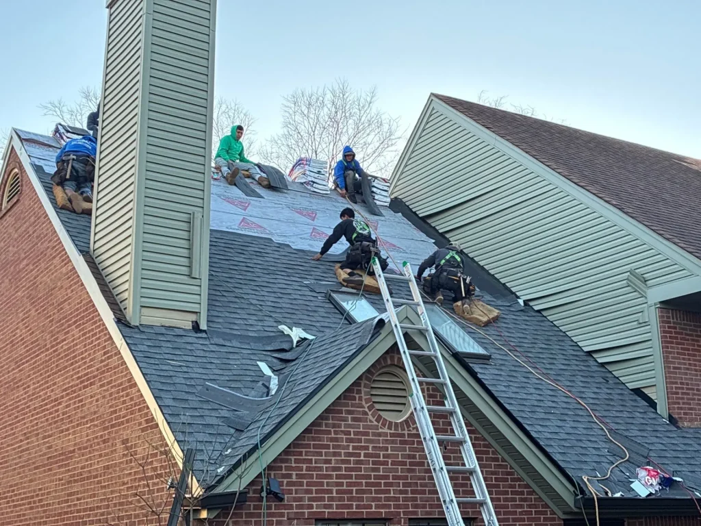 Roofing contractors repairing residential roof and replacing damaged shingles in Lexington Kentucky
