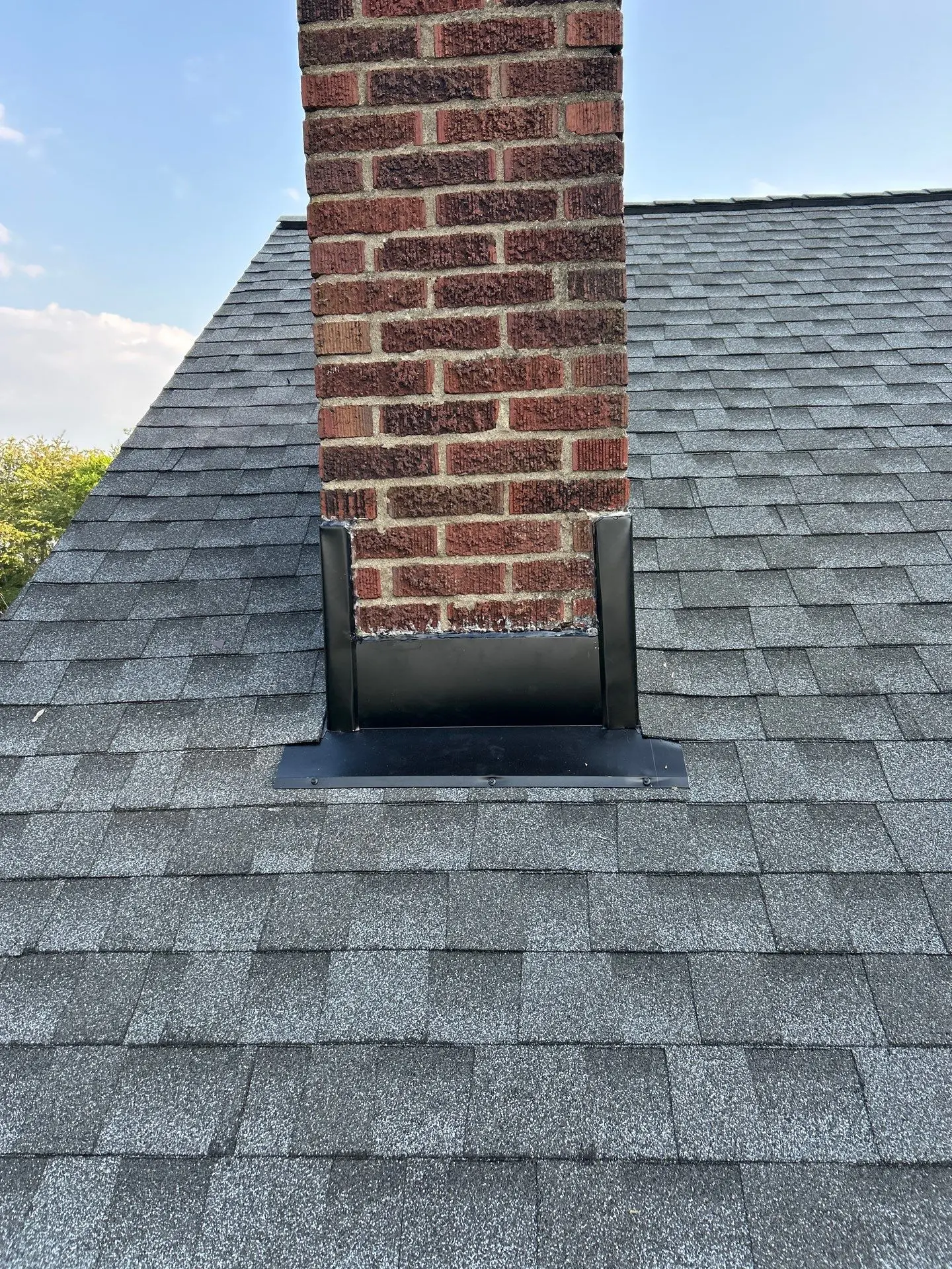 Chimney flashing installed on asphalt shingle roof in Lexington KY residential home