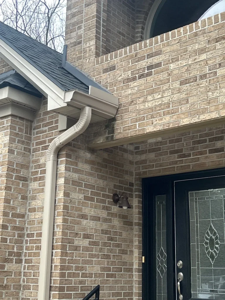 Gutter causing water staining on brick exterior near entryway in Lexington KY