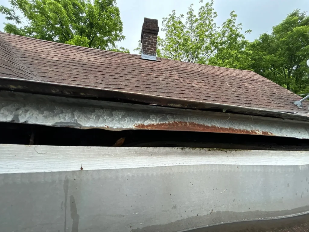 Broken Gutter with Debris on Louisville Home Gutter pulling away from house with visible gap in Lexington KY home