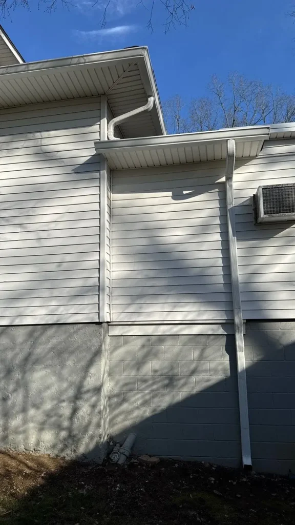 Improper downspout drainage setup with poor water direction on Lexington KY home