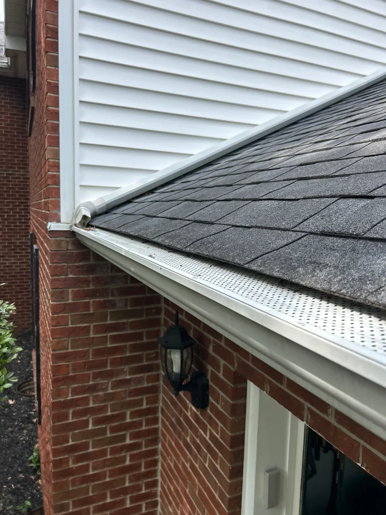 Improper gutter and downspout connection near roofline on Lexington KY home