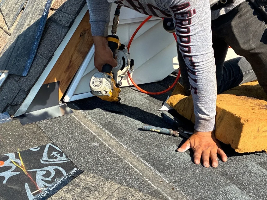 Roof repair in progress on asphalt shingle roof in Lexington KY with contractor installing shingles