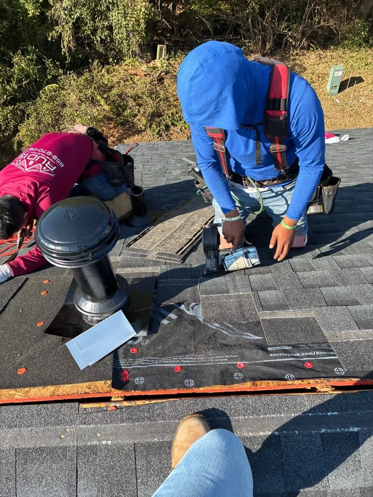 Roof vent installation and repair on asphalt shingle roof in Lexington KY with crew working