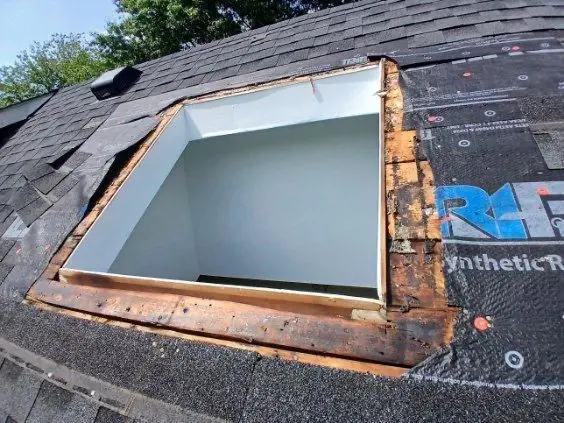 Skylight repair on roof in Lexington KY with exposed decking and flashing area