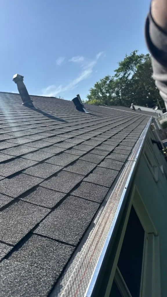 Close view of gutter guards installed along asphalt shingle roof edge on Richmond KY home