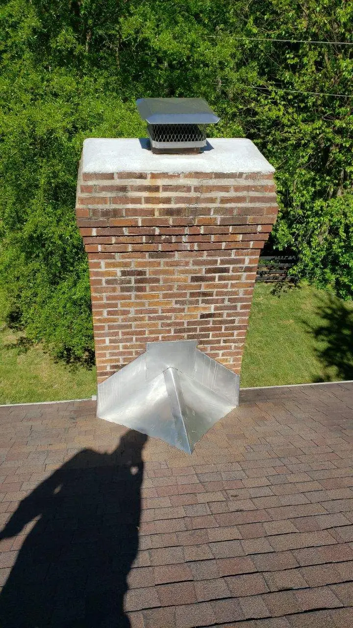 Brick chimney with metal flashing on asphalt shingle roof in Richmond KY