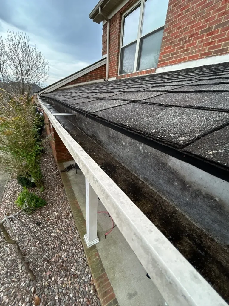 Clogged gutter with heavy debris buildup on Richmond KY home causing poor drainage