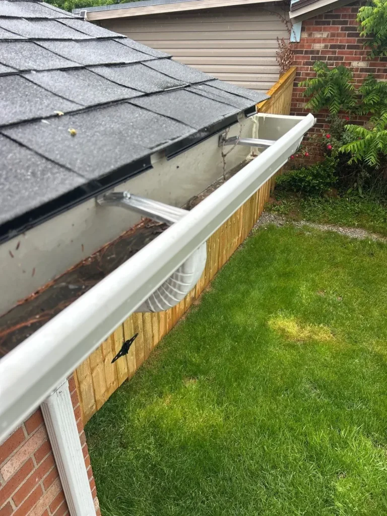 Clogged gutter with debris buildup on a Lexington KY home causing poor roof drainage