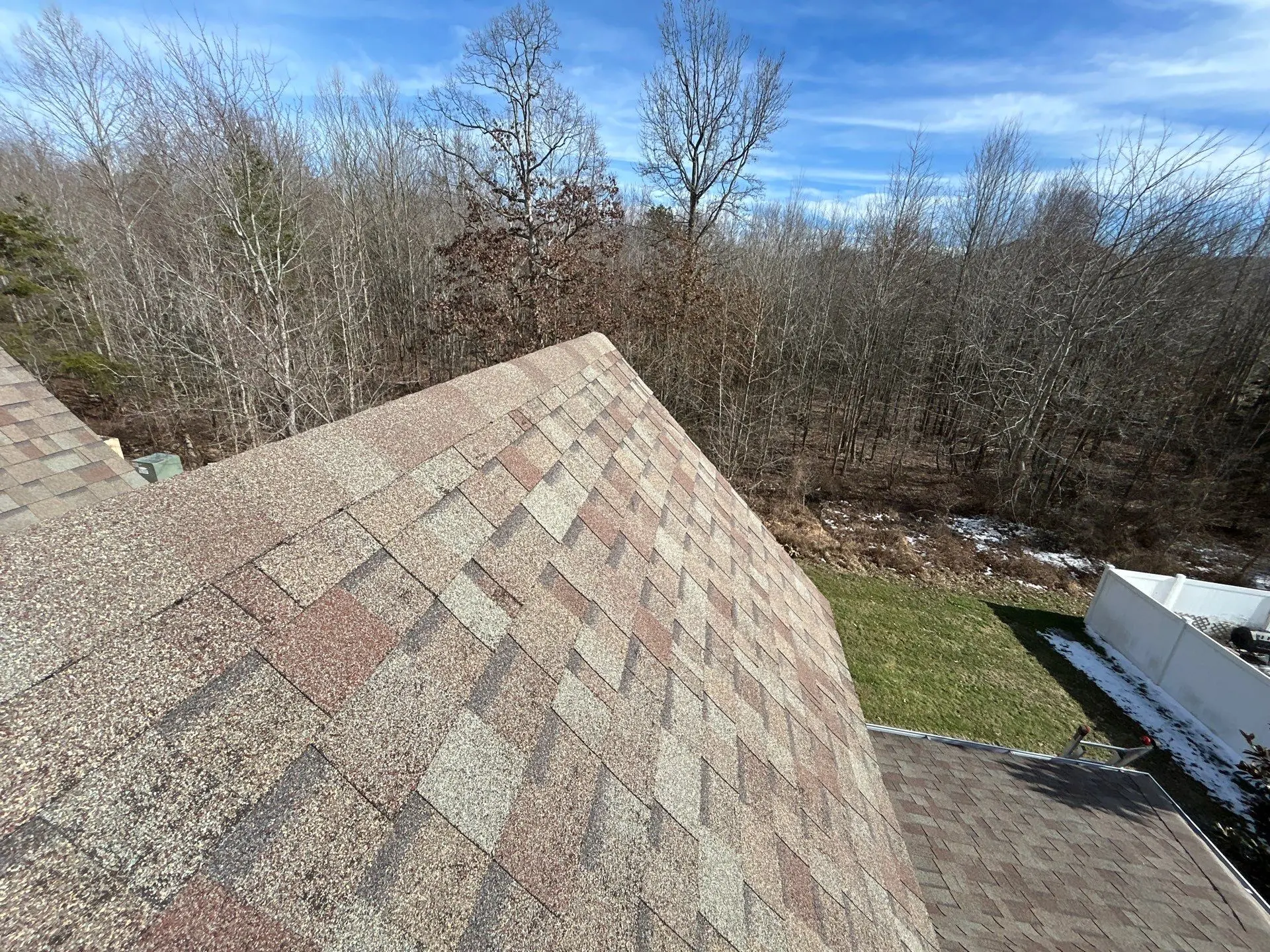 Faded asphalt shingles with color variation and wear on roof in Berea KY