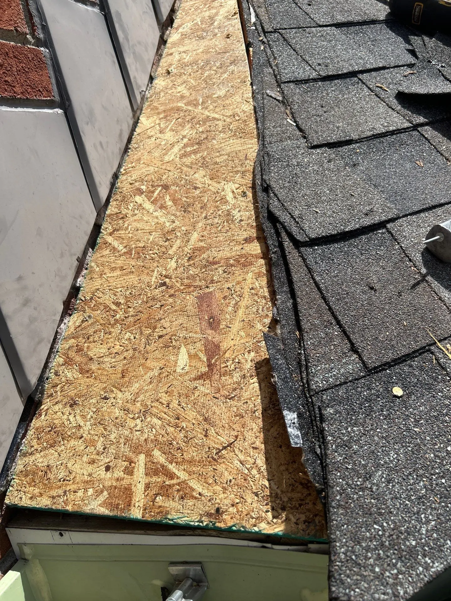 Exposed roof decking and shingle edge during roof repair in Berea KY