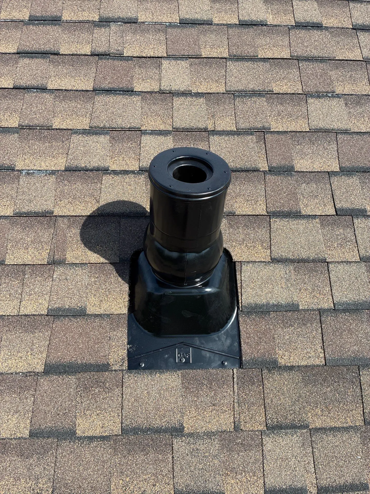 Black roof vent pipe with flashing installed on asphalt shingle roof in Richmond KY