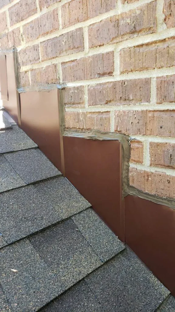 Step flashing installed along brick wall on Richmond KY roof for water protection