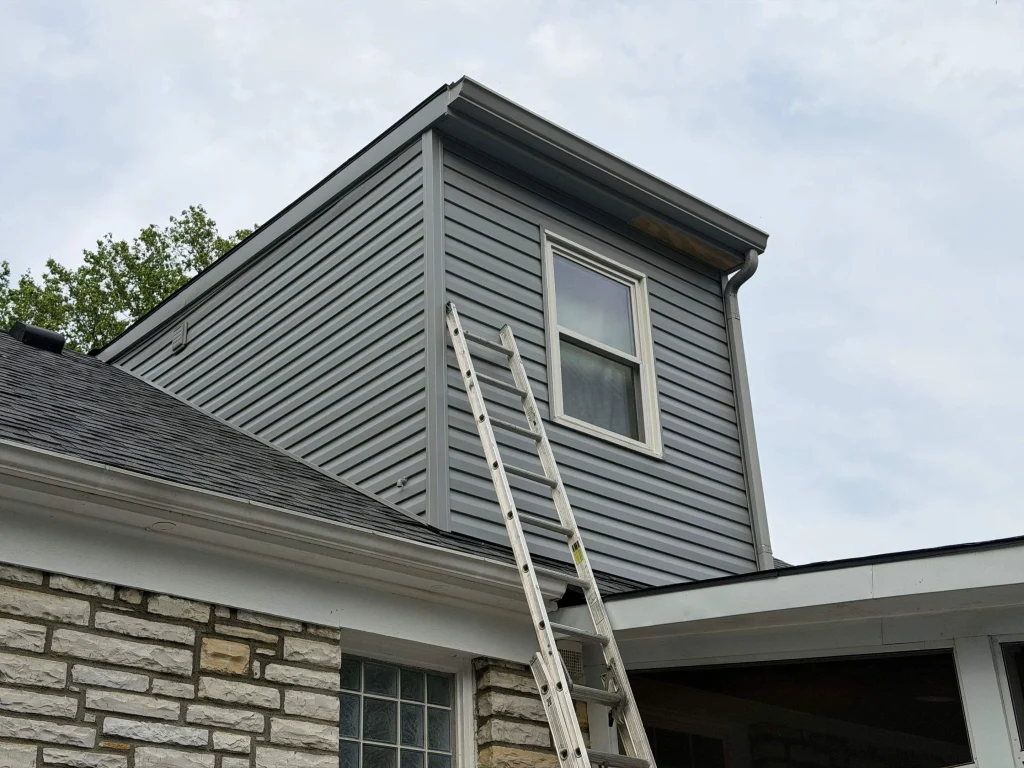 Gray vinyl siding on dormer with ladder access in Lexington KY