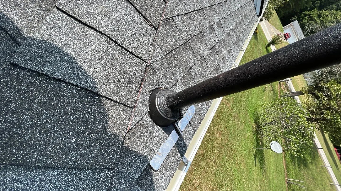 Black rubber pipe boot flashing around a vent pipe on a roof in Irvine, KY