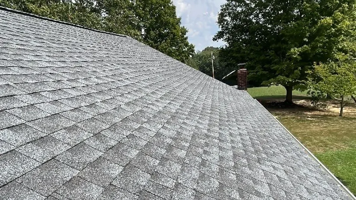 New gray architectural shingle roof with white gutter on a home in Irvine, KY