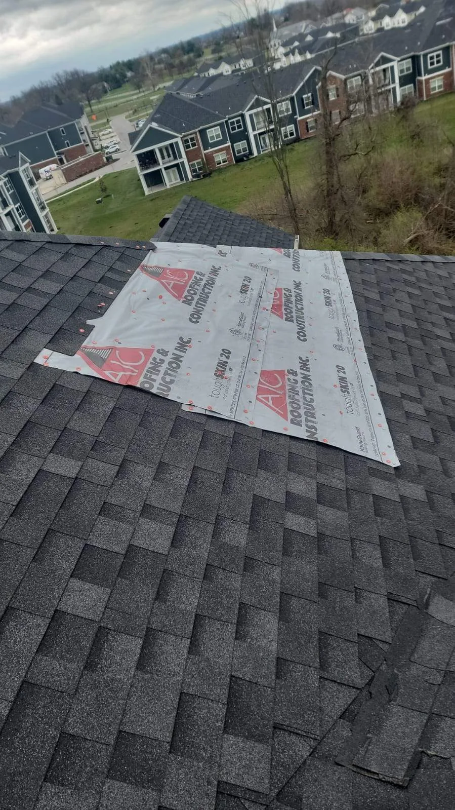 AIC Roofing and Construction branded underlayment on a Lexington, KY apartment roof above the community