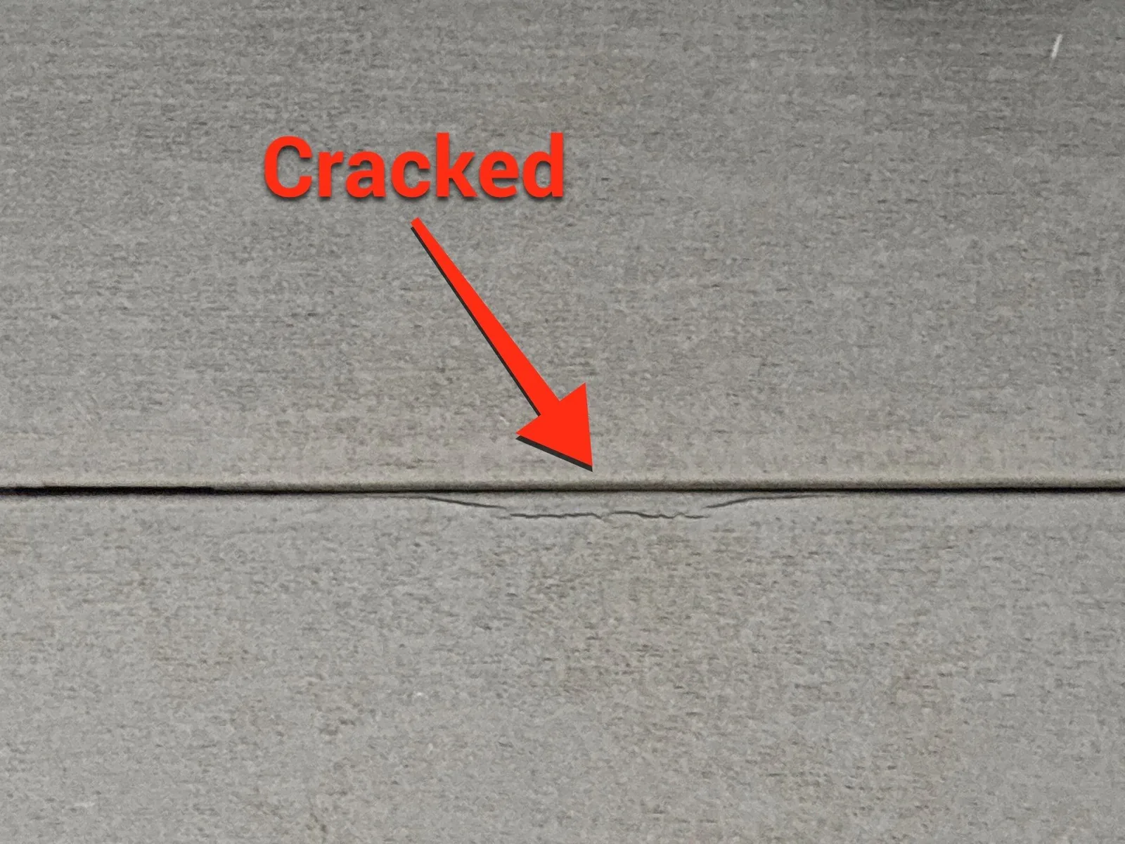 Cracked siding panel on a Louisville, KY home, a common sign replacement is needed