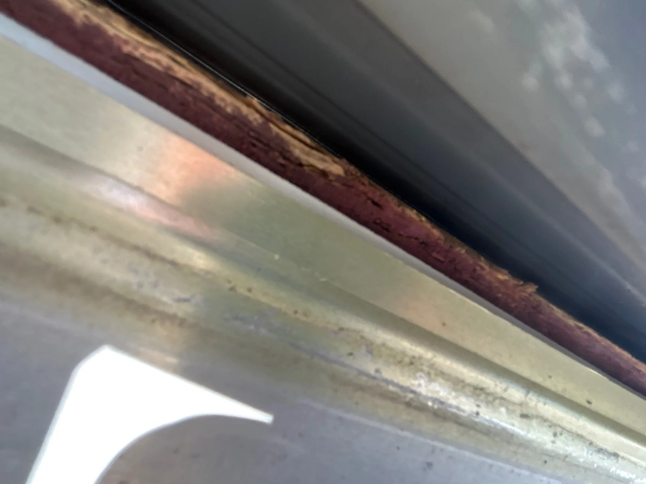 Close-up of a rusted gutter edge needing replacement on a Mt. Sterling, KY home.