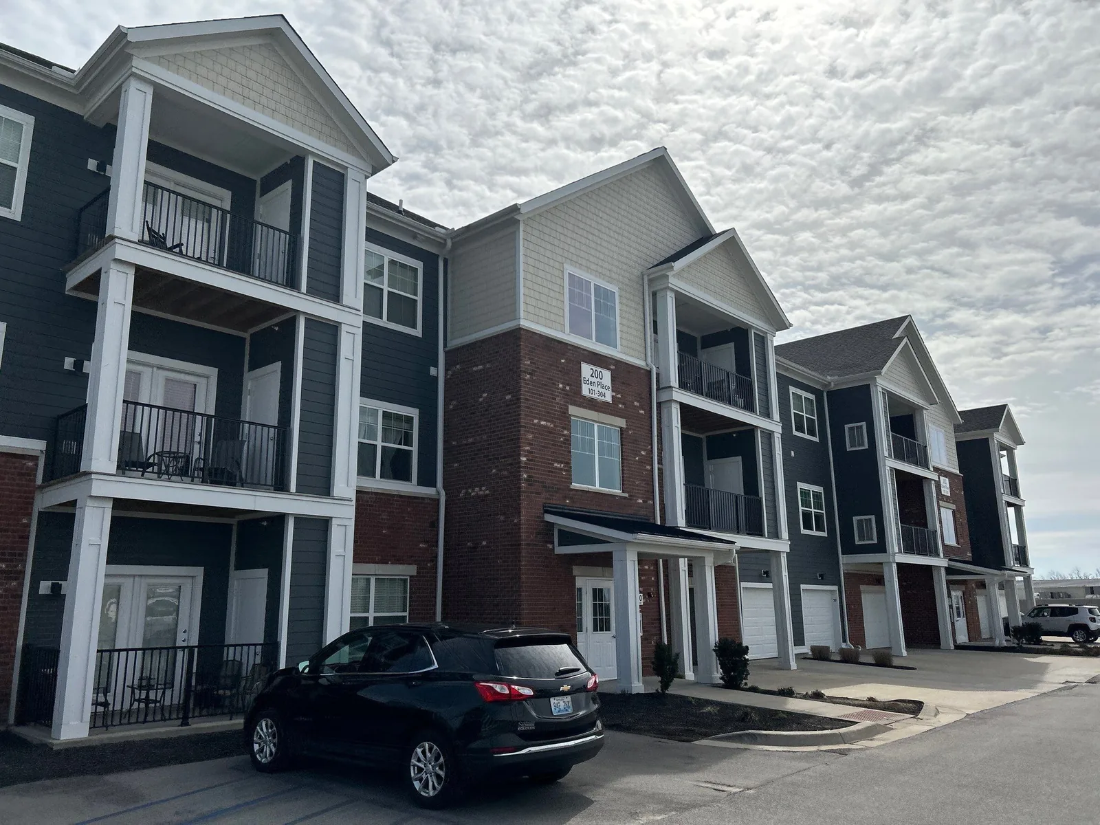 Brick and siding apartment building in Lexington, KY during a roof replacement by AIC Roofing and Construction