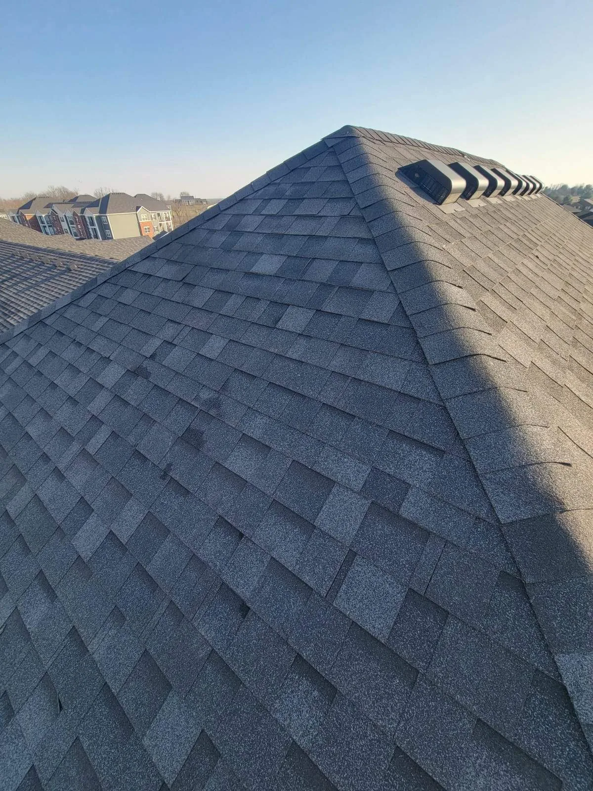Finished shingle roof on a Lexington, KY apartment building by AIC Roofing and Construction
