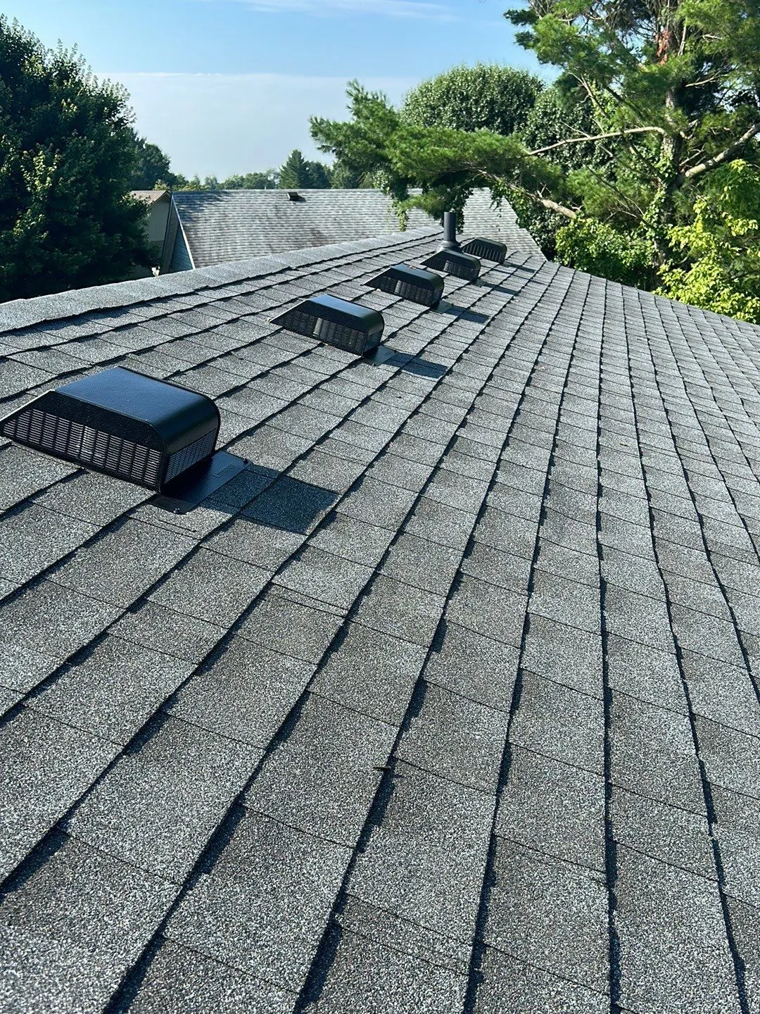 Black box vents installed along a gray shingle roof ridge in Mt. Sterling, KY