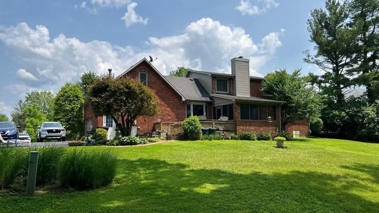 Brick two-story home with a gray shingle roof and chimney in Mt. Sterling, KY