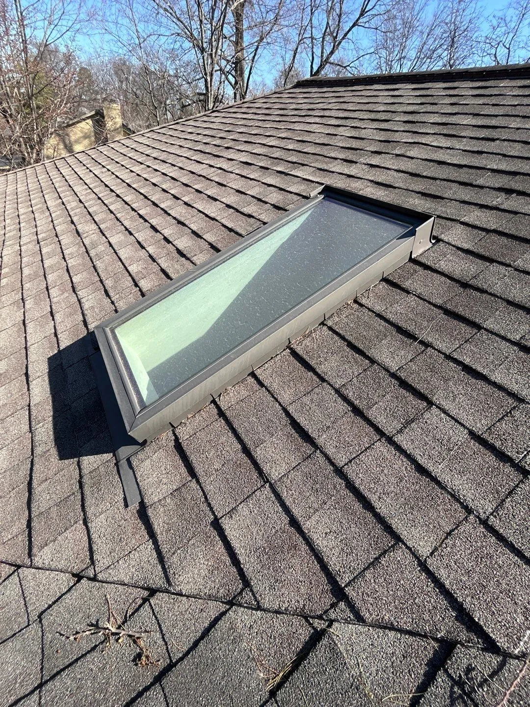 Skylight with metal flashing on a brown shingle roof in Mt. Sterling, KY