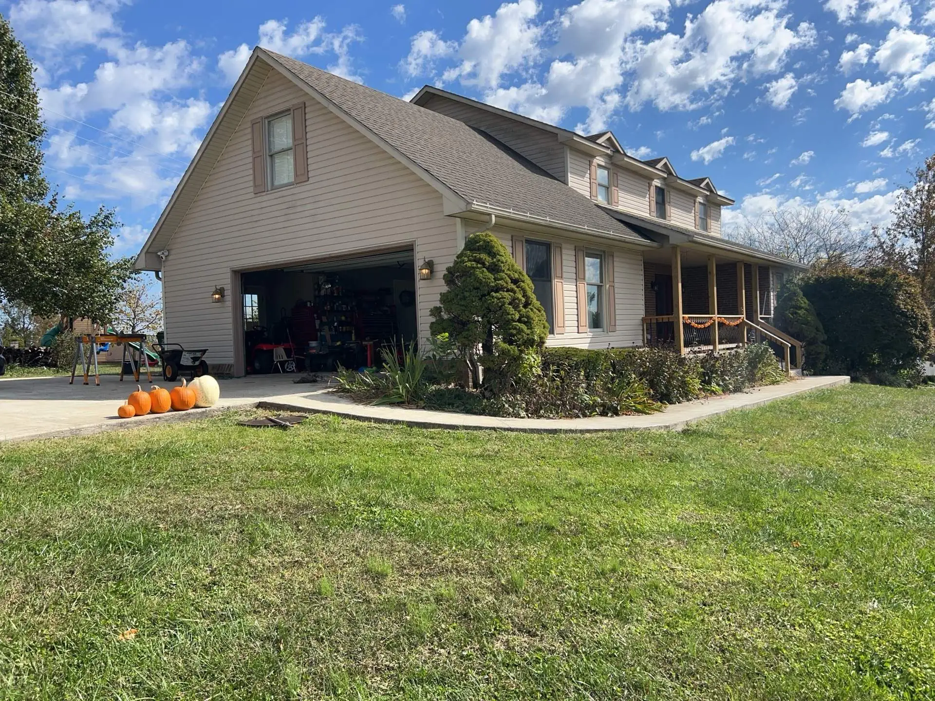 Two-story tan home with a gray shingle roof and dormers in Mt. Sterling, KY