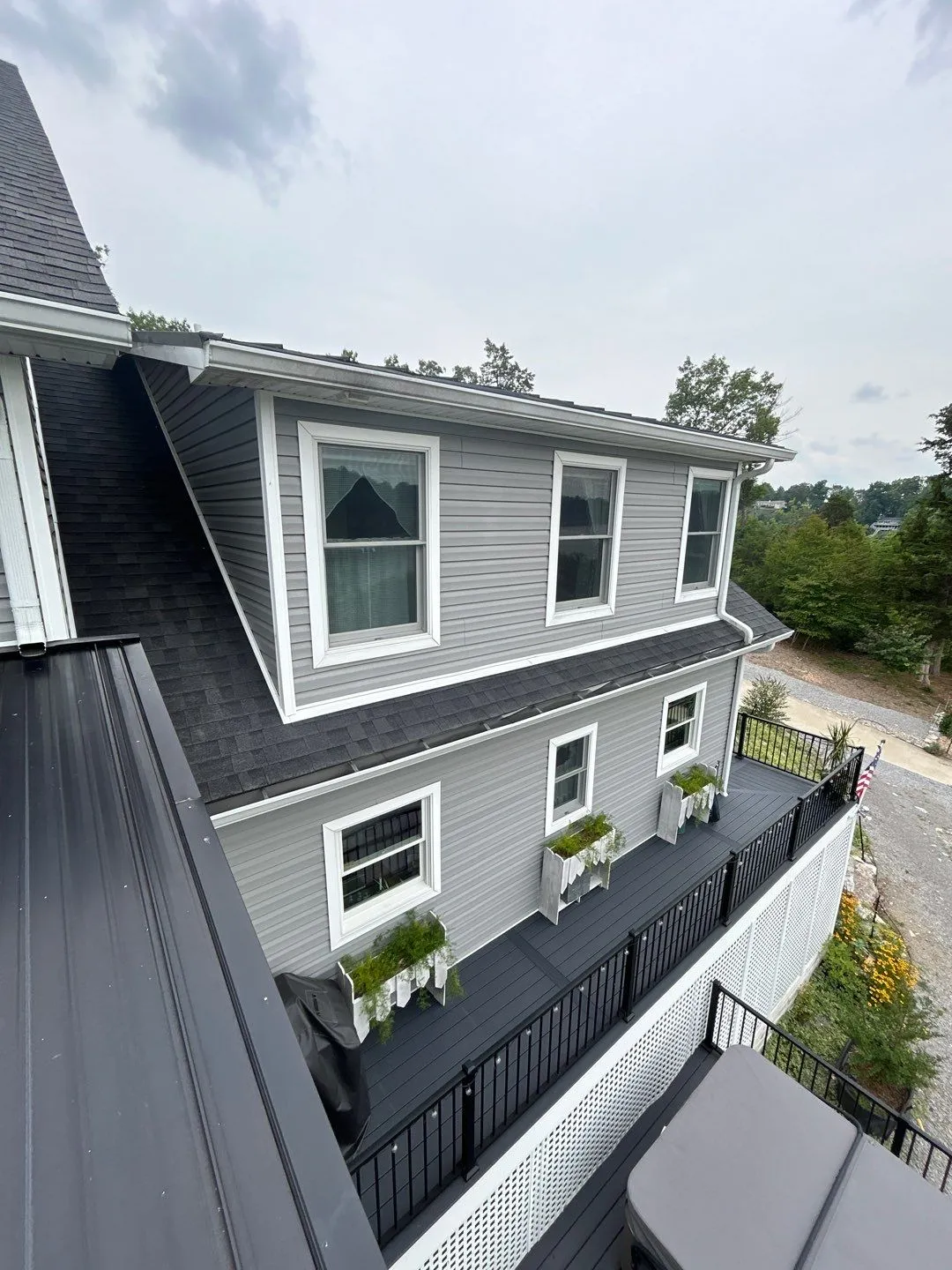 Two-story gray vinyl siding with white trim windows and a deck in Mt. Sterling, KY