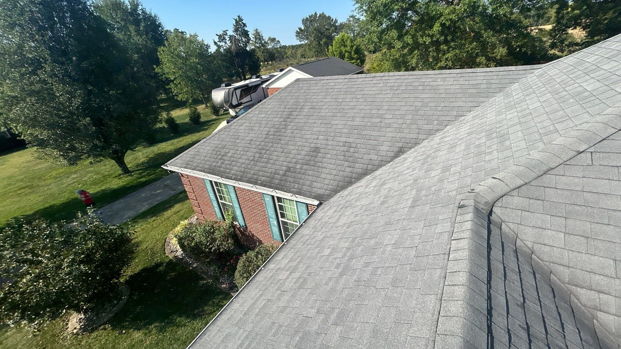 Aerial view of faded, aging shingles on a commercial property in Waco, KY.