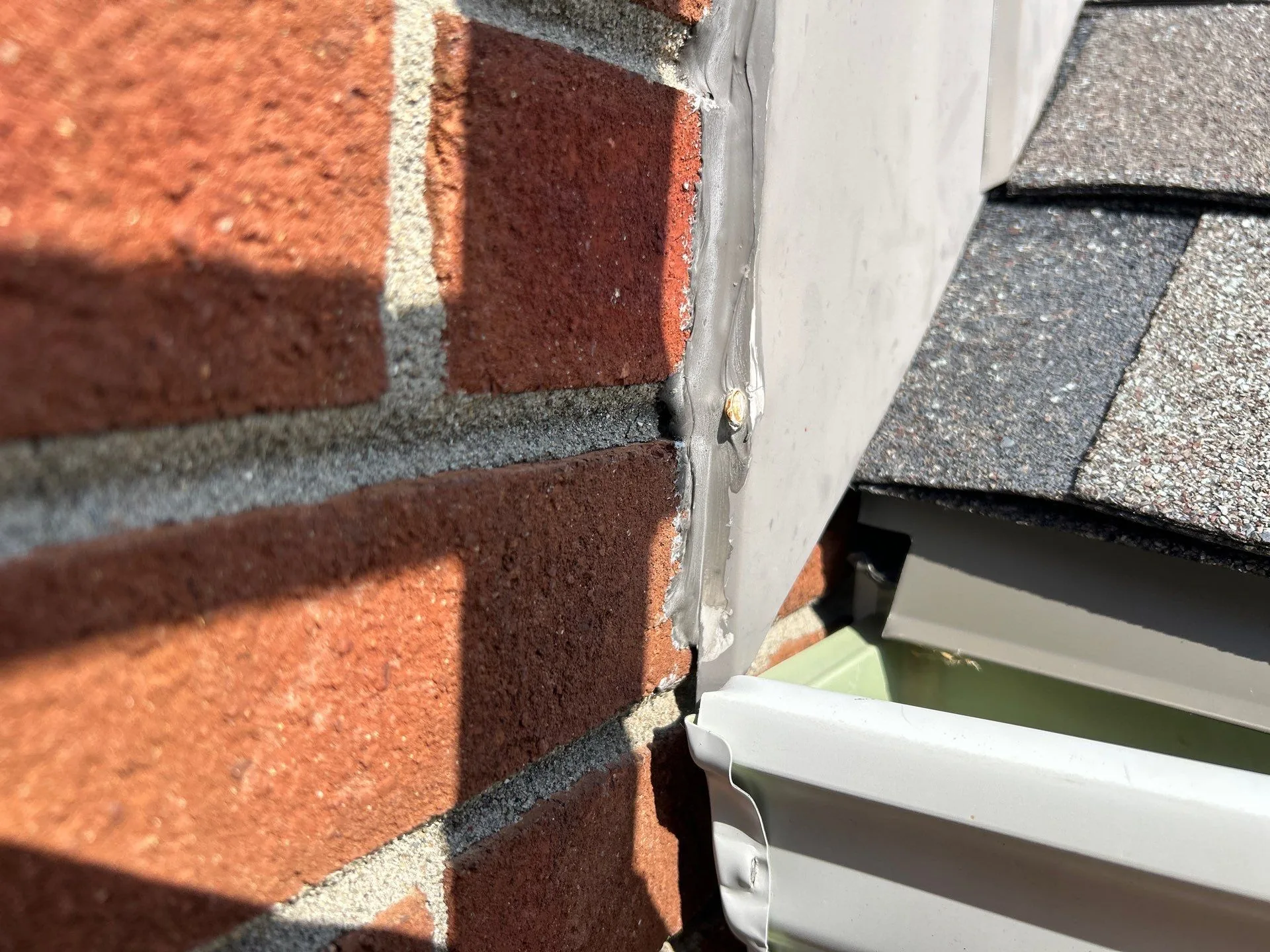 Gutter end sealed against a brick wall on a Waco, KY home.
